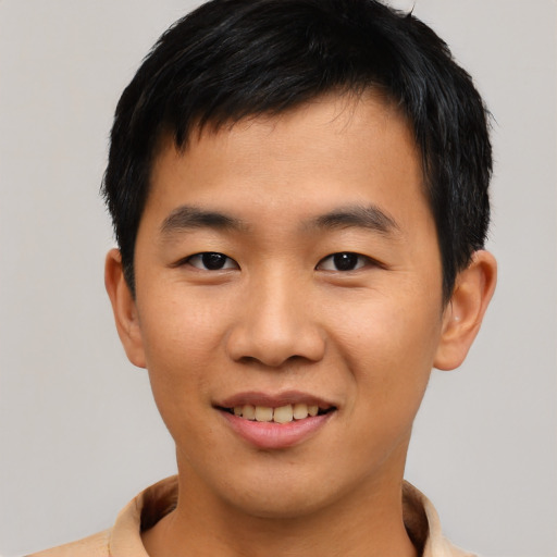 Joyful asian young-adult male with short  brown hair and brown eyes