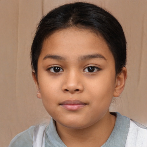 Joyful latino child female with short  brown hair and brown eyes