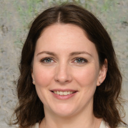 Joyful white young-adult female with medium  brown hair and green eyes