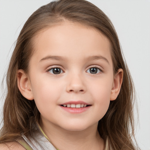 Joyful white child female with long  brown hair and grey eyes