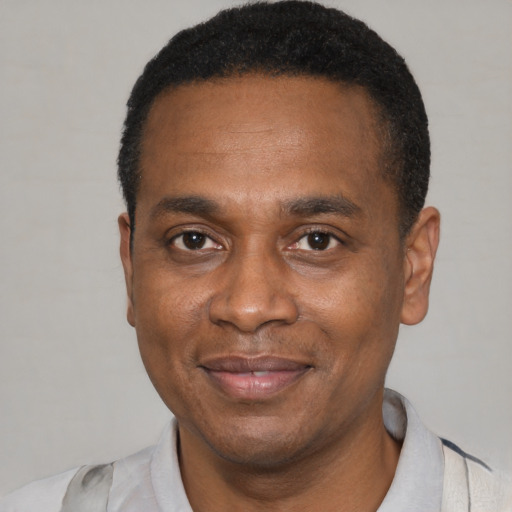 Joyful latino adult male with short  black hair and brown eyes