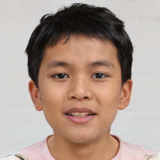 Joyful asian child male with short  brown hair and brown eyes