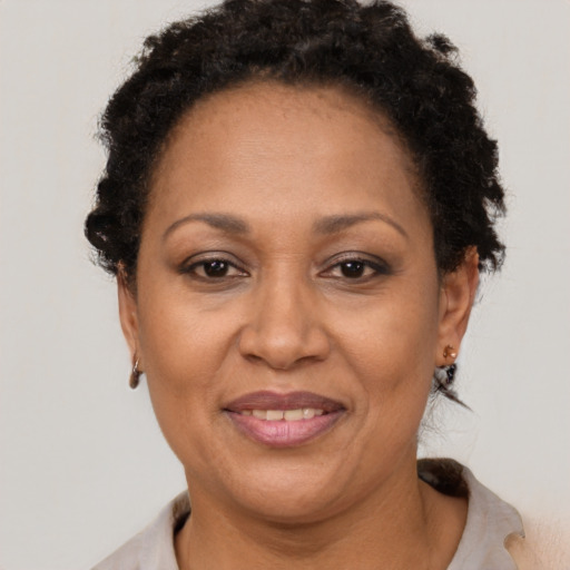 Joyful black adult female with short  brown hair and brown eyes