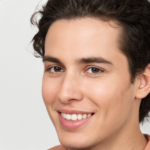 Joyful white young-adult male with medium  brown hair and brown eyes