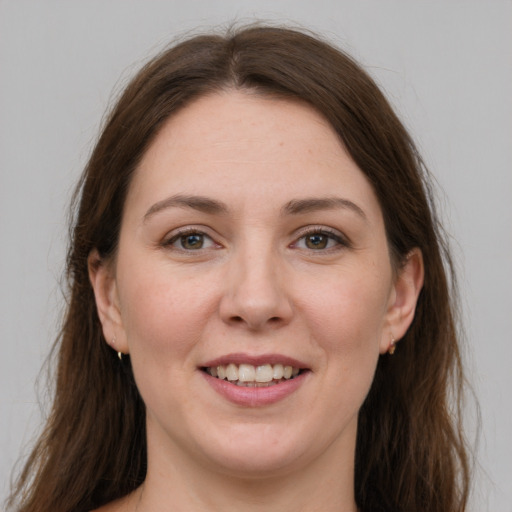 Joyful white young-adult female with long  brown hair and grey eyes