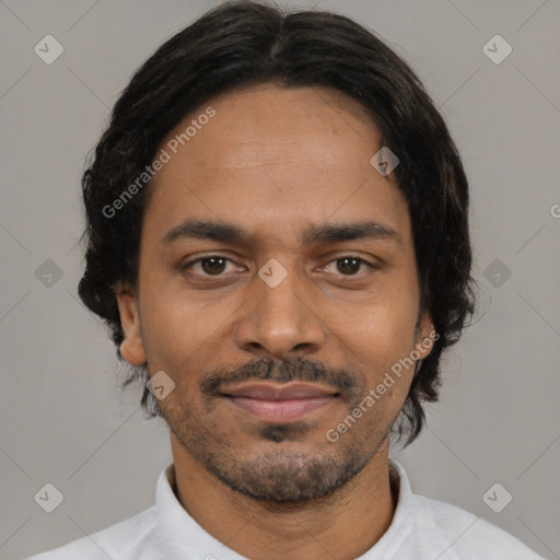 Joyful black young-adult male with short  brown hair and brown eyes