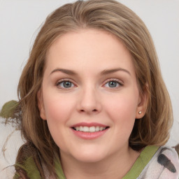 Joyful white young-adult female with medium  brown hair and green eyes