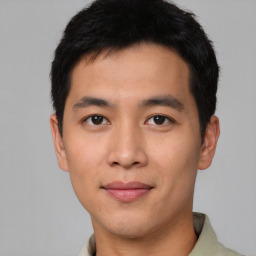 Joyful asian young-adult male with short  black hair and brown eyes