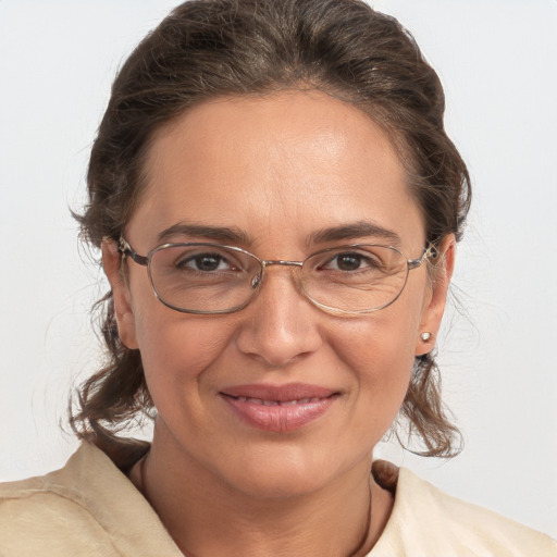 Joyful white adult female with medium  brown hair and grey eyes