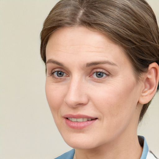 Joyful white adult female with medium  brown hair and blue eyes