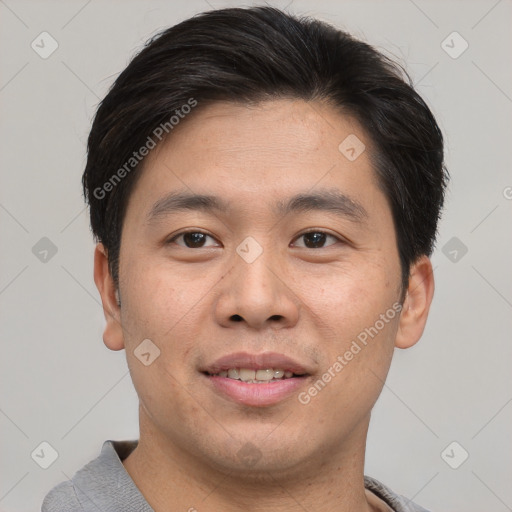 Joyful asian young-adult male with short  brown hair and brown eyes