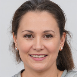 Joyful white adult female with medium  brown hair and brown eyes