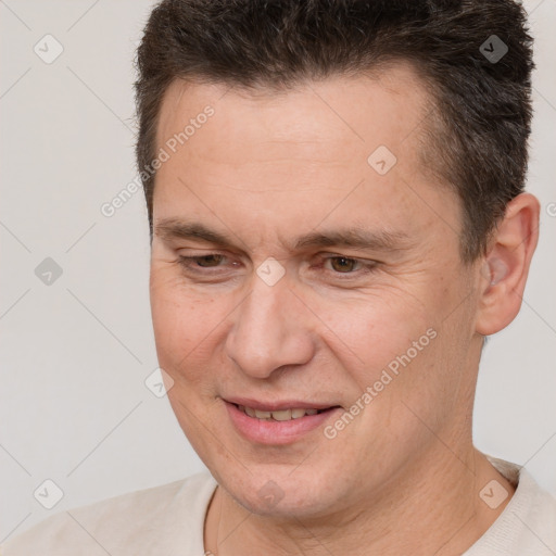 Joyful white adult male with short  brown hair and brown eyes