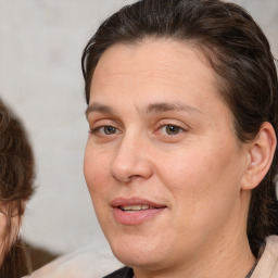 Joyful white adult female with medium  brown hair and brown eyes