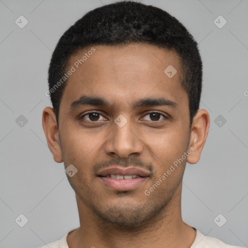 Joyful black young-adult male with short  black hair and brown eyes