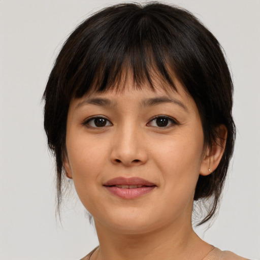Joyful asian young-adult female with medium  brown hair and brown eyes