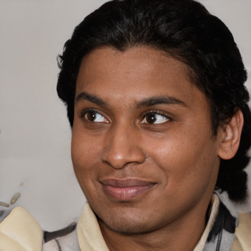 Joyful latino young-adult male with short  brown hair and brown eyes