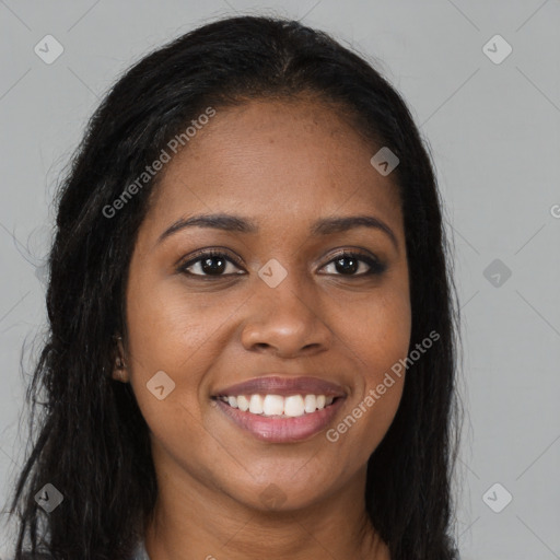 Joyful black young-adult female with long  brown hair and brown eyes