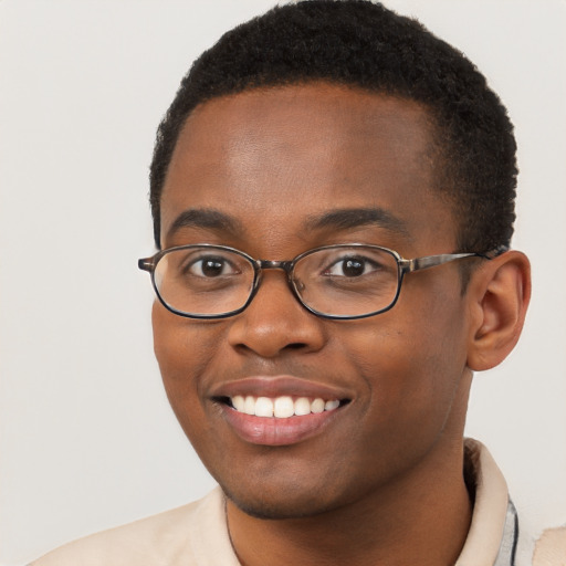 Joyful black young-adult male with short  brown hair and brown eyes