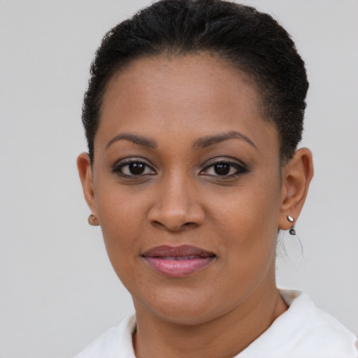 Joyful black young-adult female with short  brown hair and brown eyes