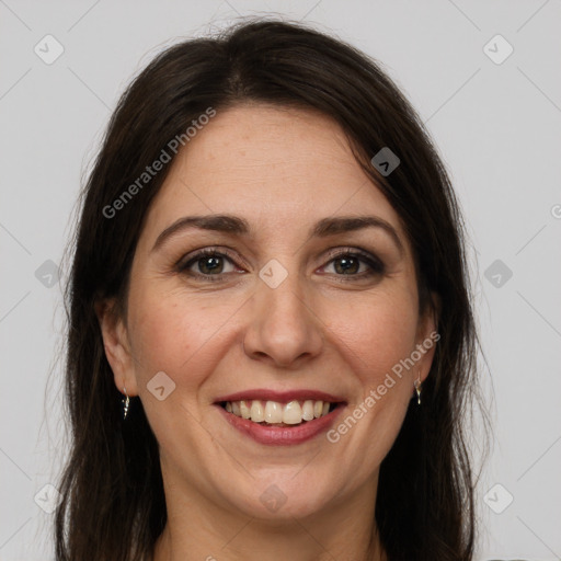 Joyful white adult female with long  brown hair and grey eyes