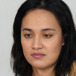 Joyful asian young-adult female with long  brown hair and brown eyes