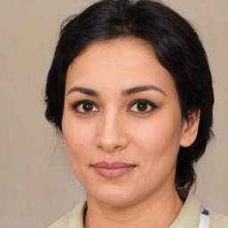 Joyful latino young-adult female with medium  brown hair and brown eyes