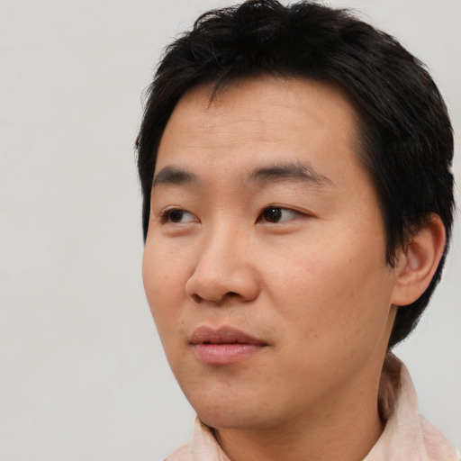 Neutral asian young-adult male with short  brown hair and brown eyes