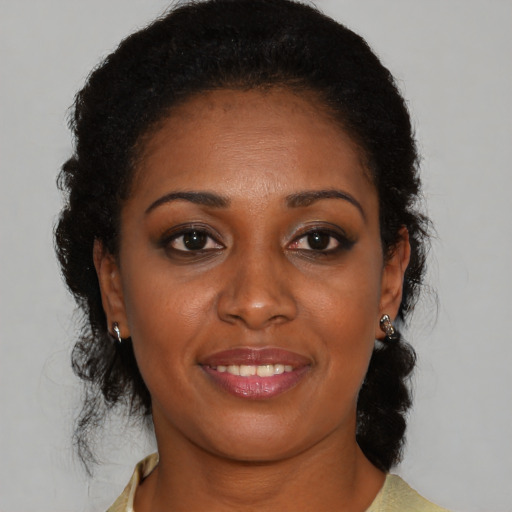 Joyful black young-adult female with medium  brown hair and brown eyes