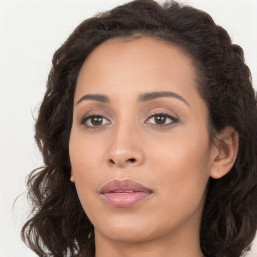 Joyful white young-adult female with long  brown hair and brown eyes