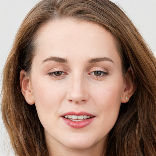 Joyful white young-adult female with long  brown hair and blue eyes