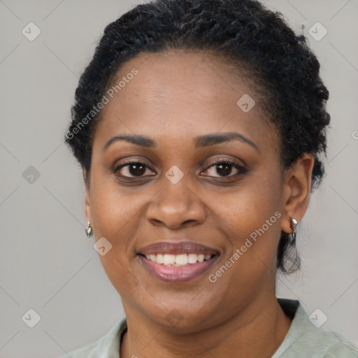 Joyful black adult female with short  brown hair and brown eyes