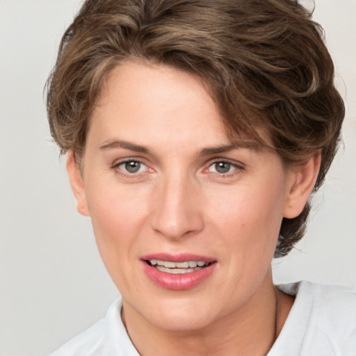 Joyful white adult female with short  brown hair and brown eyes