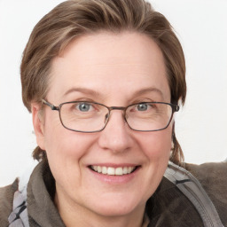 Joyful white adult female with medium  brown hair and blue eyes