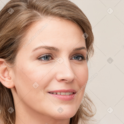 Joyful white young-adult female with long  brown hair and blue eyes