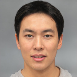 Joyful asian young-adult male with short  brown hair and brown eyes