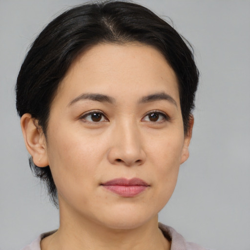 Joyful latino young-adult female with short  black hair and brown eyes