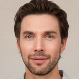 Joyful white young-adult male with short  brown hair and grey eyes