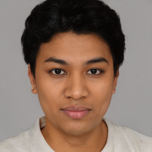 Joyful latino young-adult female with short  black hair and brown eyes