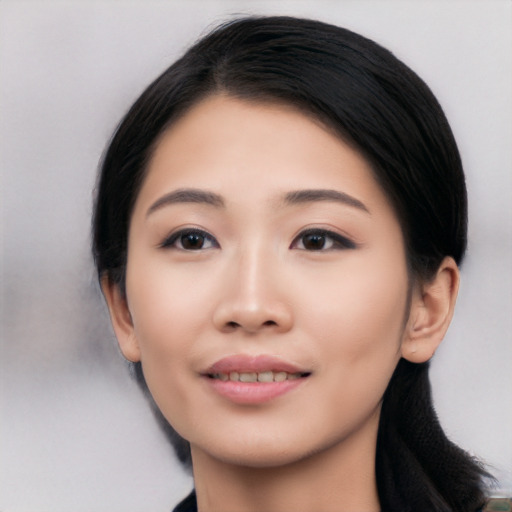 Joyful asian young-adult female with medium  black hair and brown eyes