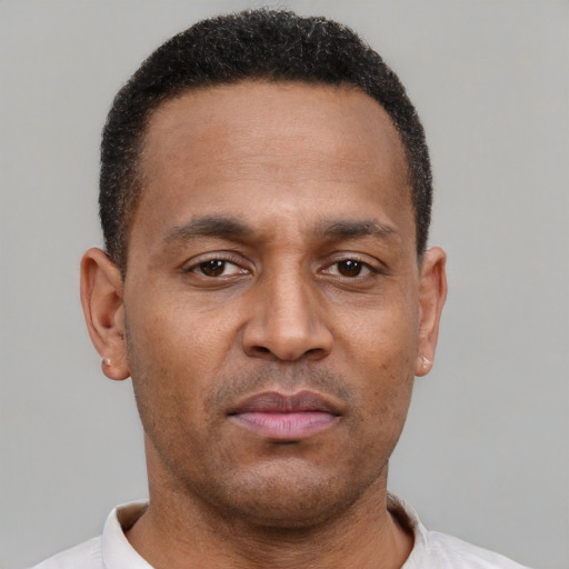 Neutral latino adult male with short  brown hair and brown eyes