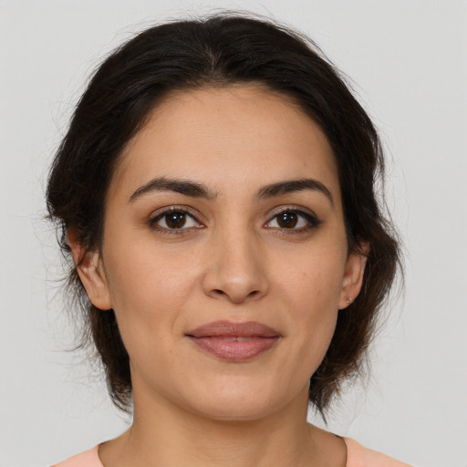 Joyful white young-adult female with medium  brown hair and brown eyes