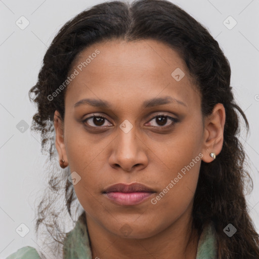 Joyful black young-adult female with long  brown hair and brown eyes