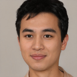 Joyful asian young-adult male with short  black hair and brown eyes