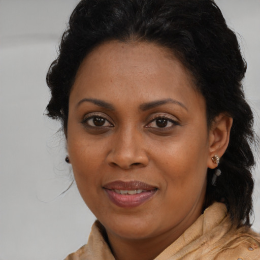Joyful black young-adult female with medium  brown hair and brown eyes