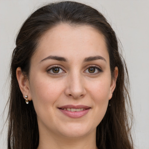 Joyful white young-adult female with long  brown hair and grey eyes