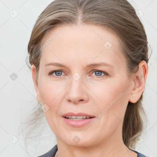 Joyful white adult female with medium  brown hair and grey eyes