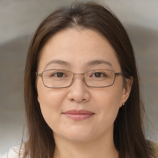 Joyful white adult female with long  brown hair and brown eyes