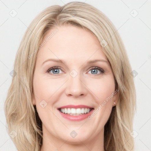 Joyful white young-adult female with long  brown hair and blue eyes