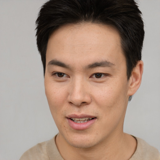Joyful asian young-adult male with short  brown hair and brown eyes